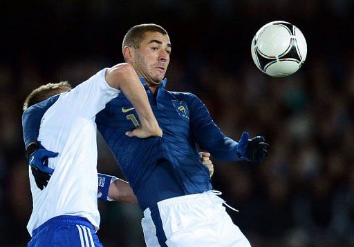 French forward Karim Benzema (R) clashes with Finland's captain Niklas Moisander